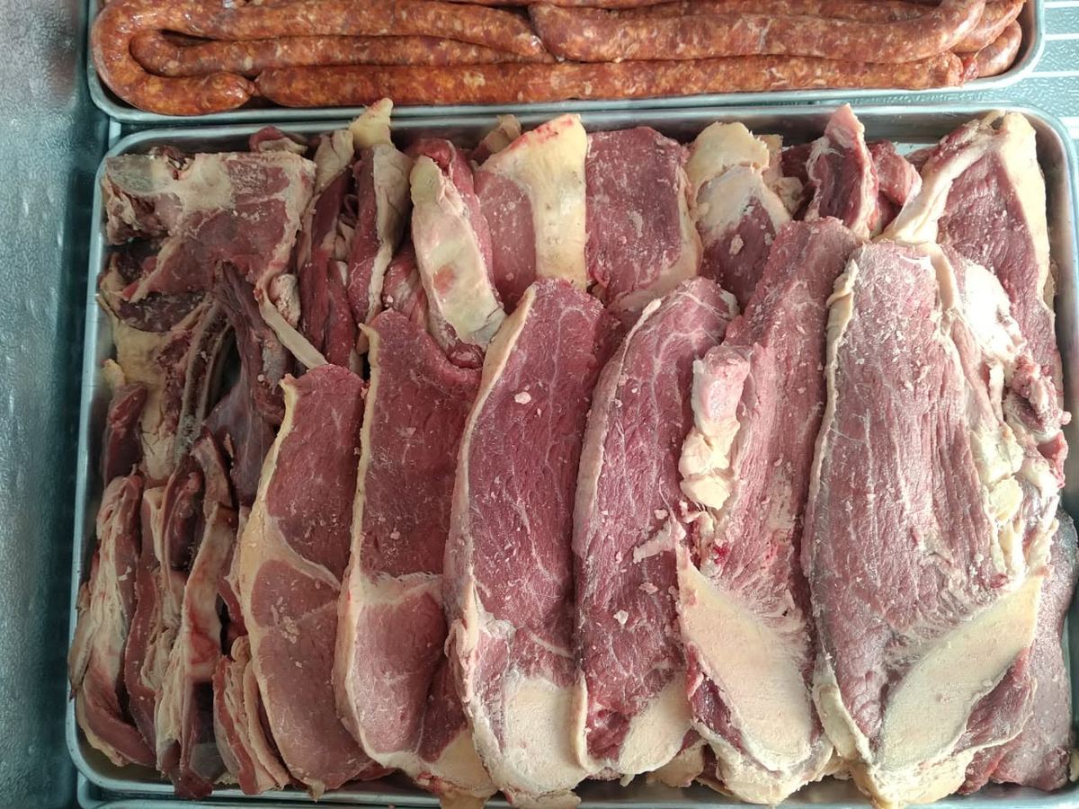 Trays of brisket and sausage in the butchery chiller