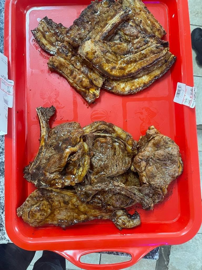 Braaied ribs and chops on a red tray